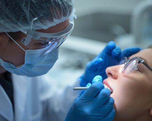 photos of dentists working on patient, both with glasses the dentist with covered hair and gloves